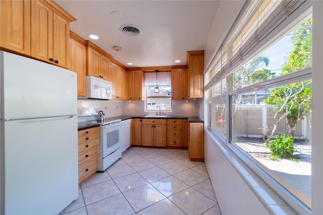 kitchen with backsplash, white appliances, sink, and light tile patterned floors