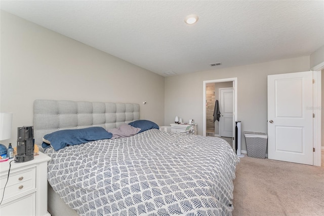 carpeted bedroom with a textured ceiling