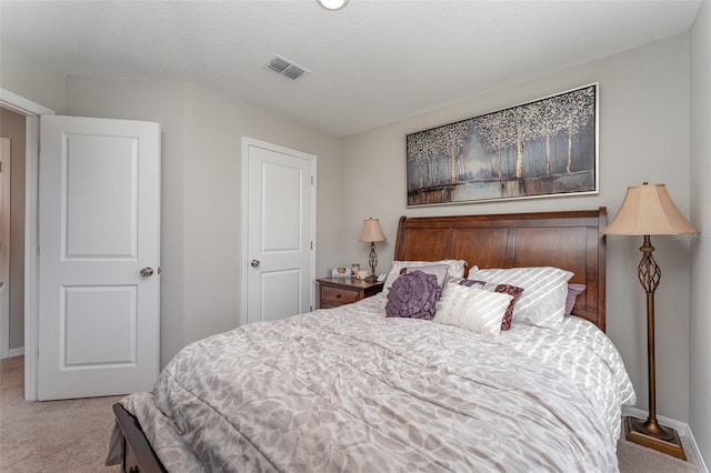 carpeted bedroom with a textured ceiling