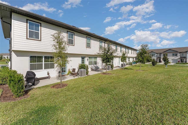 back of house with a lawn, central AC, and a patio