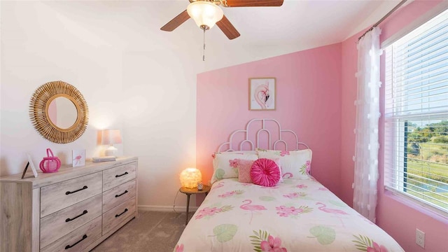 carpeted bedroom with multiple windows, ceiling fan, and lofted ceiling