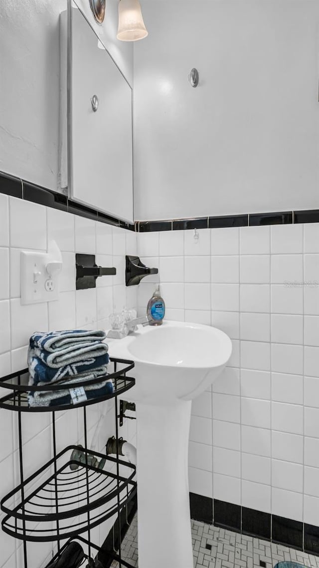 bathroom with tile patterned floors and tile walls