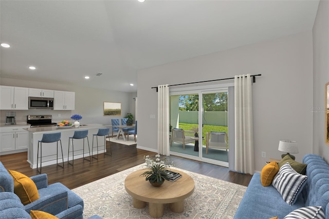 living room with dark hardwood / wood-style flooring