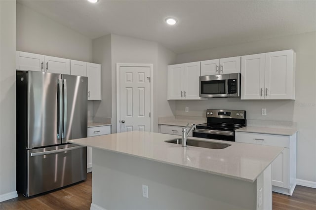 kitchen featuring white cabinetry, sink, stainless steel appliances, dark hardwood / wood-style flooring, and a center island with sink