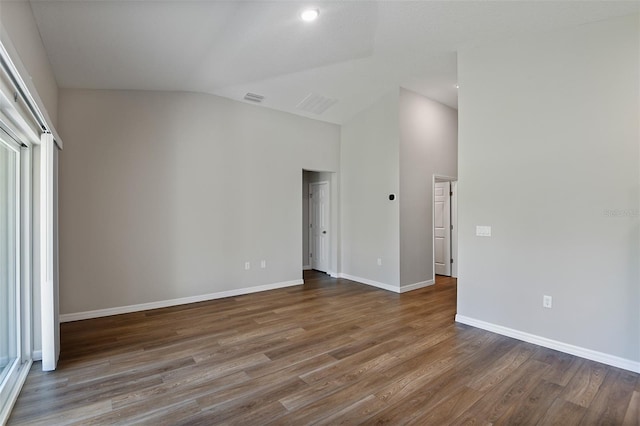 unfurnished room featuring wood-type flooring and vaulted ceiling