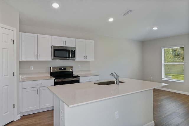 kitchen with white cabinetry, a center island with sink, sink, and appliances with stainless steel finishes