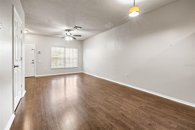 empty room with a textured ceiling, ceiling fan, and dark wood-type flooring