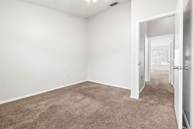 empty room with carpet flooring and ceiling fan