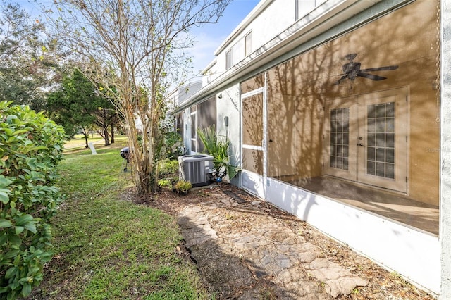 view of home's exterior featuring cooling unit and ceiling fan