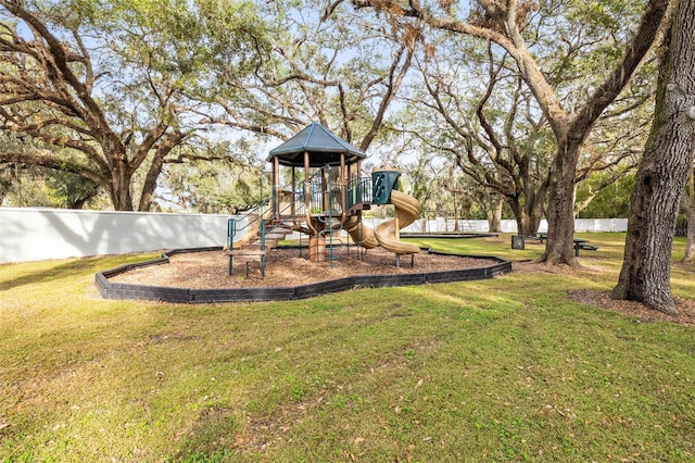 view of jungle gym featuring a lawn