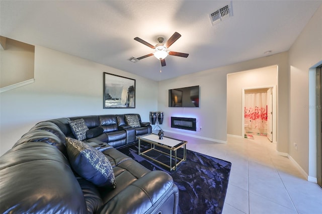 tiled living room featuring ceiling fan and a textured ceiling