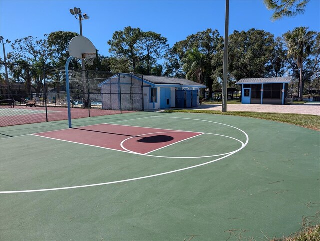 view of basketball court featuring tennis court