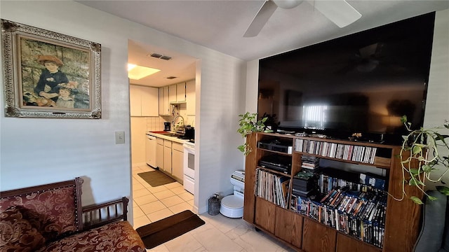 living room with ceiling fan and light tile patterned floors