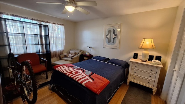 bedroom with hardwood / wood-style flooring and ceiling fan