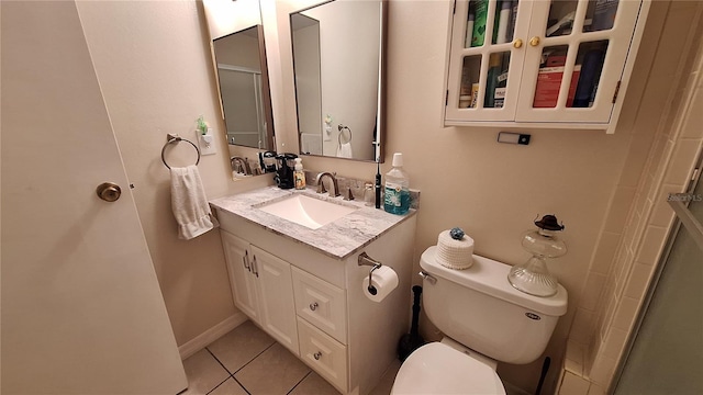 bathroom with toilet, tile patterned flooring, vanity, and a shower with door