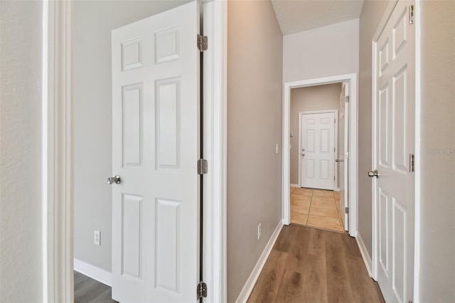 corridor featuring dark hardwood / wood-style flooring