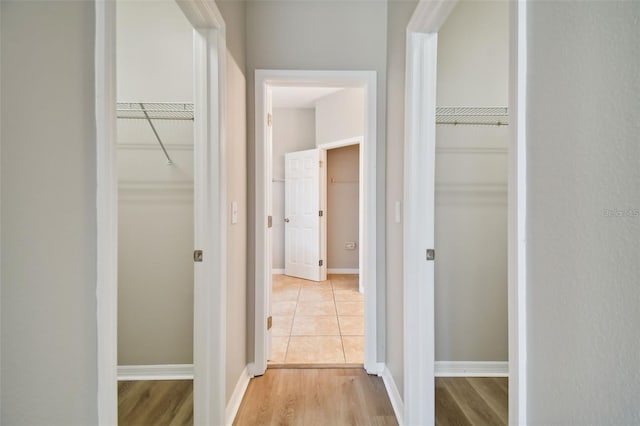 hallway with light hardwood / wood-style floors