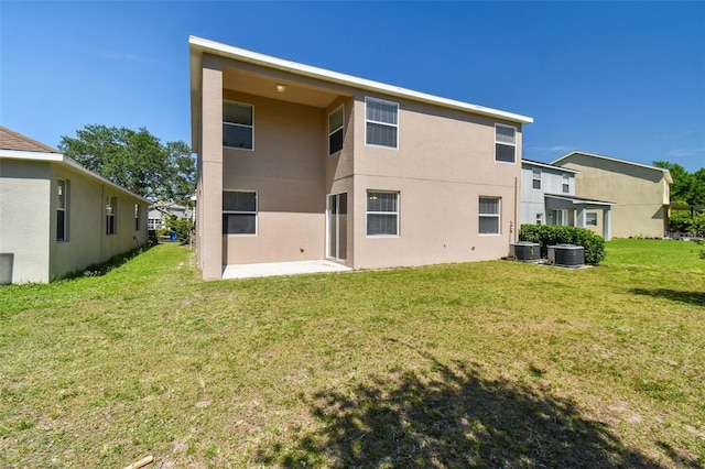 back of property featuring a patio, central AC unit, and a lawn