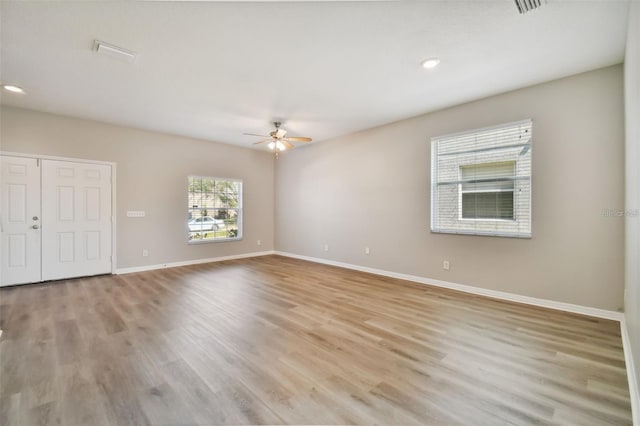 unfurnished room featuring light hardwood / wood-style floors and ceiling fan