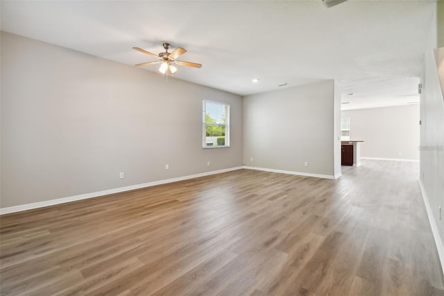 empty room featuring hardwood / wood-style floors and ceiling fan