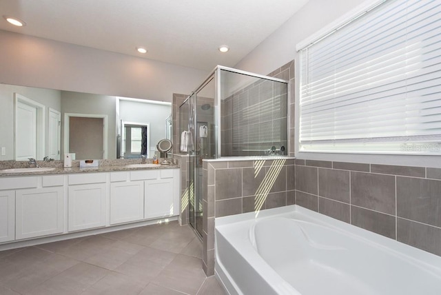 bathroom with tile patterned flooring, vanity, and shower with separate bathtub