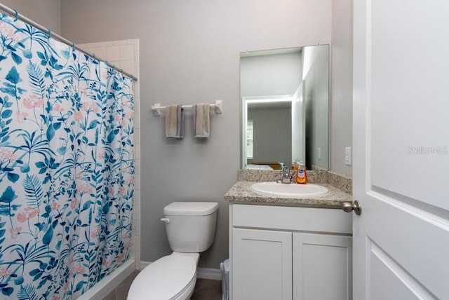 bathroom featuring vanity, curtained shower, and toilet