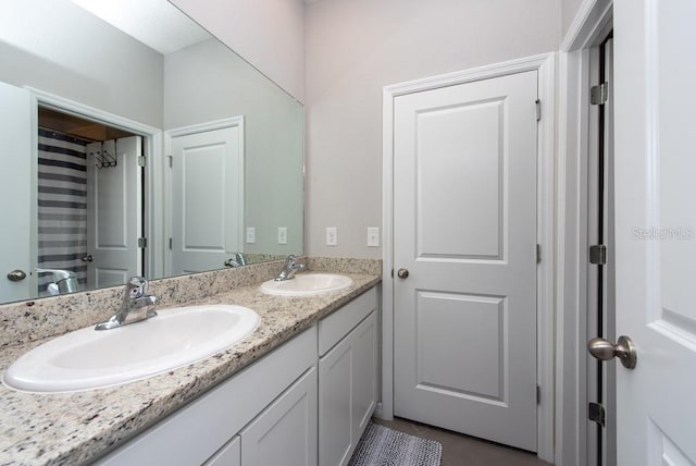 bathroom with tile patterned floors and vanity