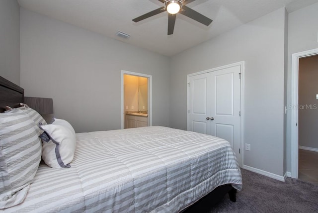 carpeted bedroom featuring ensuite bath, ceiling fan, and a closet