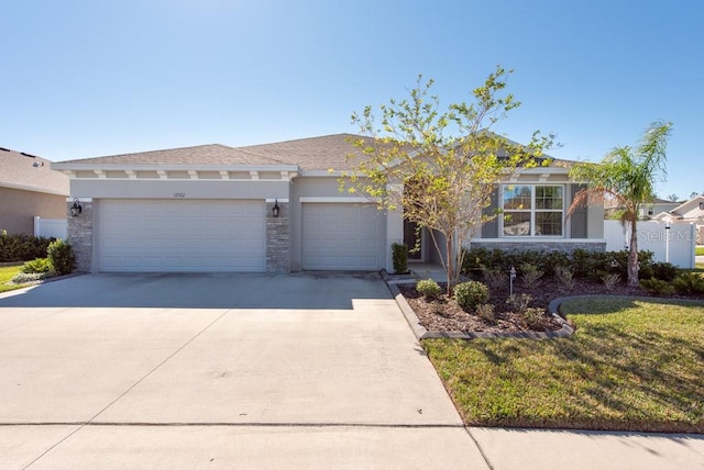 view of front of property featuring a front lawn and a garage