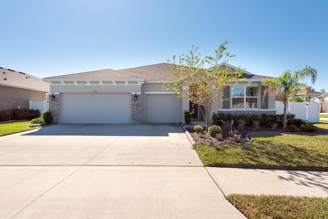 view of front of house with a garage and a front lawn