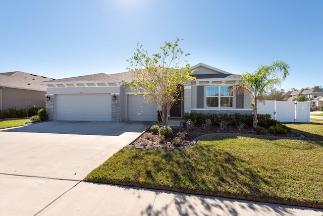 view of front of house featuring a front lawn and a garage