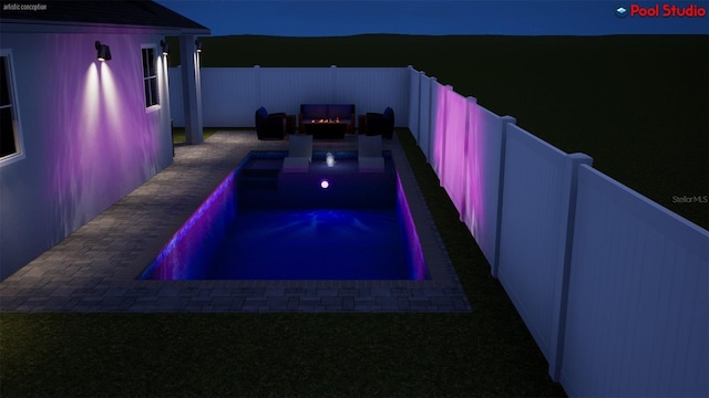 pool at night featuring a fire pit