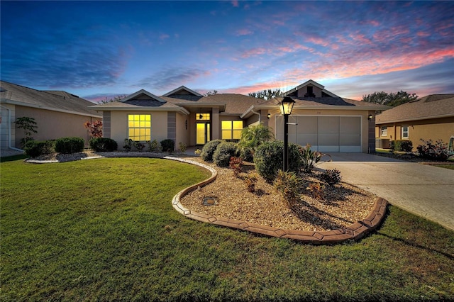 view of front of home featuring a lawn and a garage