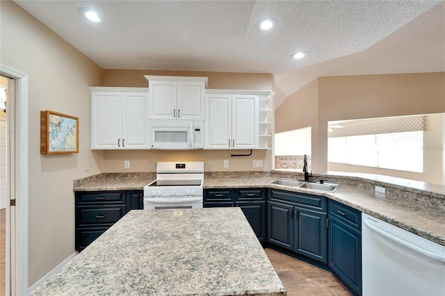 kitchen featuring a textured ceiling, white appliances, blue cabinets, sink, and white cabinetry