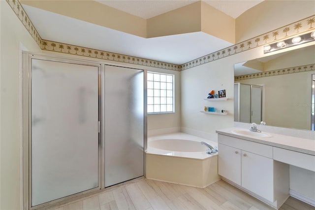 bathroom featuring vanity, wood-type flooring, a textured ceiling, and plus walk in shower