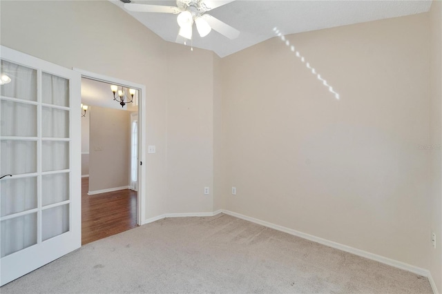 carpeted empty room with ceiling fan with notable chandelier