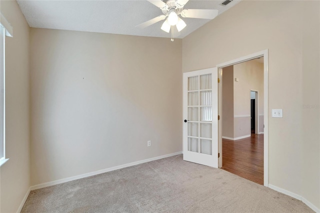 empty room with carpet flooring, ceiling fan, and french doors