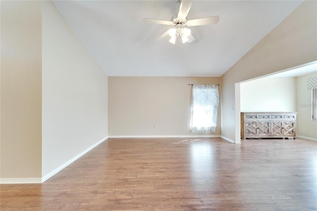 interior space with ceiling fan, light hardwood / wood-style floors, a textured ceiling, and vaulted ceiling