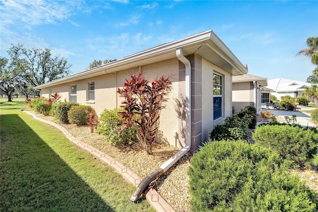 view of side of property with a lawn