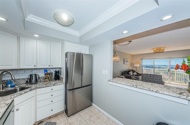 kitchen featuring white cabinets, decorative backsplash, sink, and appliances with stainless steel finishes