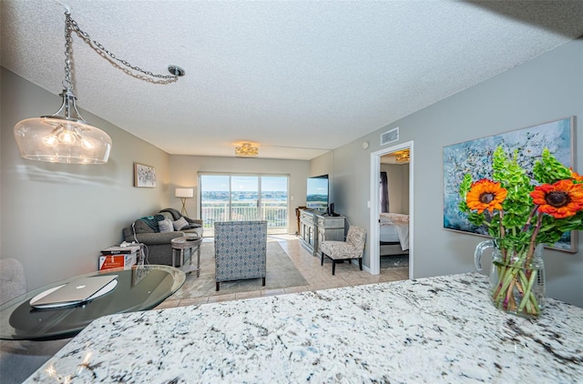 bedroom featuring a textured ceiling and light tile patterned flooring