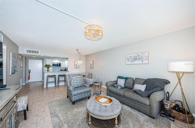 living room featuring light tile patterned floors and a textured ceiling