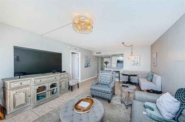 living room with light tile patterned floors and a textured ceiling