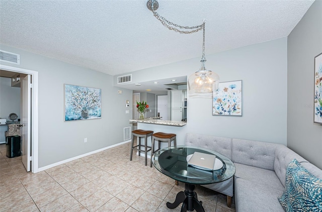 tiled living room with a textured ceiling