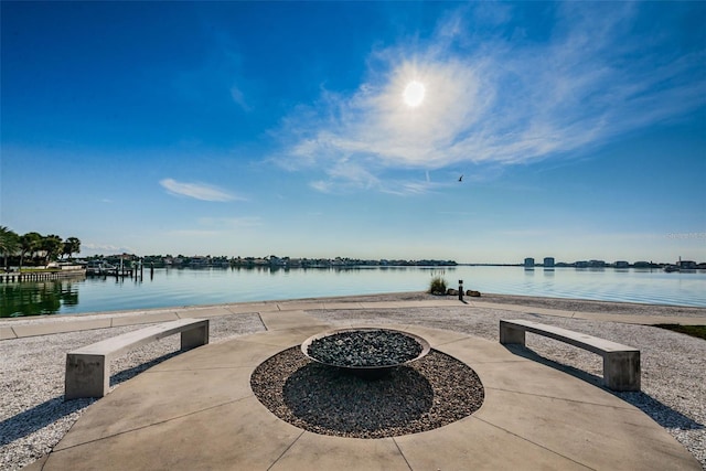 view of patio / terrace with a water view and an outdoor fire pit