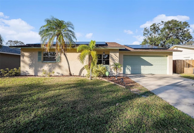 ranch-style house featuring solar panels, a front lawn, and a garage