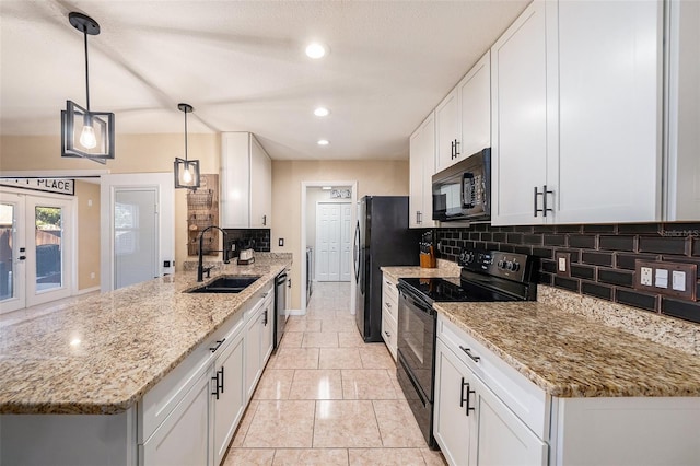 kitchen with white cabinetry, hanging light fixtures, and black appliances