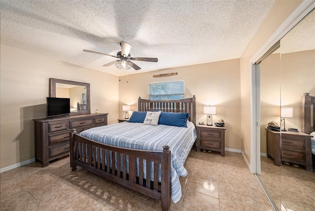 bedroom featuring light tile patterned floors, a textured ceiling, and ceiling fan