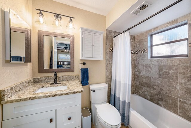 full bathroom with vanity, ceiling fan, toilet, and shower / tub combo with curtain