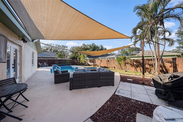 view of patio with french doors and a fenced in pool